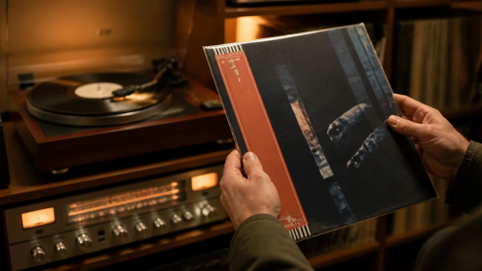 Collector examining a Japanese vinyl LP with a red obi strip beside a turntable